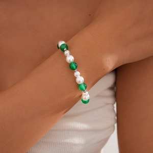 Close-up of beaded necklace with white pearls, green agate beads, and silver spacers