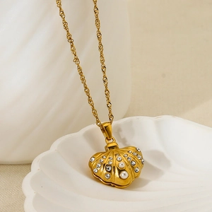 Golden shell locket necklace with pearls and zircon crystals on a classic twist chain