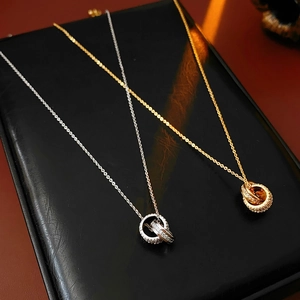 Detail of 18K gold and silver plated double circle necklaces with sparkling zircons