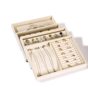 Beige velvet jewelry organizer trays with multiple slots for rings and necklaces
