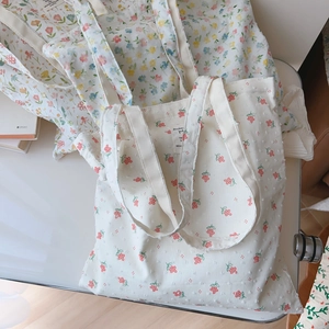 Detail of floral cotton tote bag showing textured fabric and pink blue flower patterns