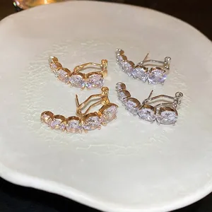 Elegant gold and silver curved zircon stud earrings set with five sparkling gradient stones
