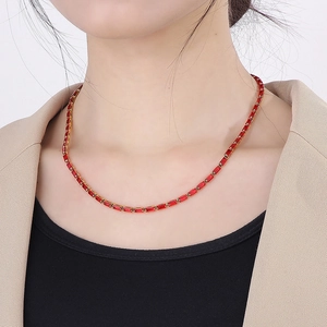 Detail of elegant 18K gold plated necklace featuring vibrant red square-cut zircon stones