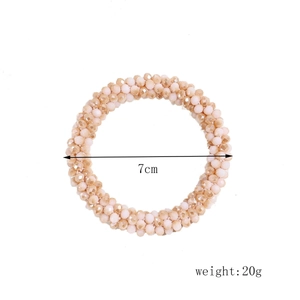 Detail view of champagne beaded hair tie showing 7cm diameter and 20g weight spec
