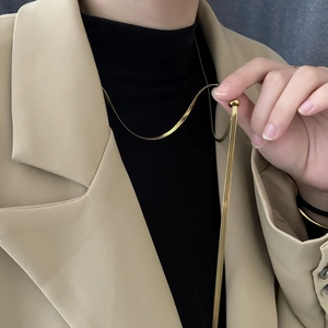 Minimalist adjustable gold snake bone sweater chain necklace worn with an elegant outfit