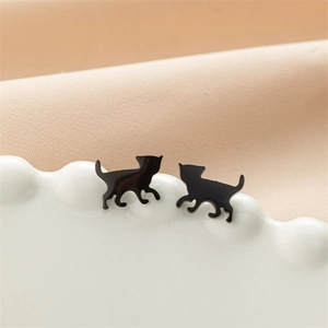 Detailed view of glossy black cat silhouette stud earrings in polished stainless steel