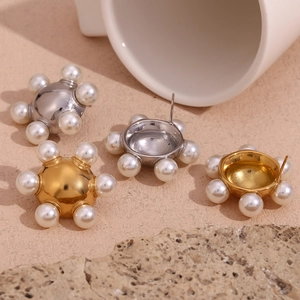 18K gold and silver wheel earrings with central metallic sphere and white pearls