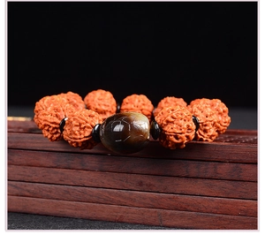 Macro shot of Nepal Rudraksha Bodhi beads bracelet with dark brown tiger eye stone