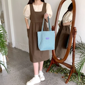 Blue and white plaid canvas tote bag styled with a minimalist brown dress and shirt