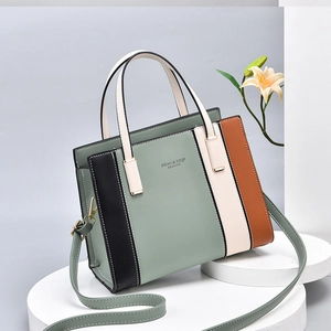 Stylish patchwork PU leather handbag with top handle and shoulder strap in soft tones