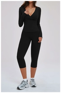 Close-up of black high-stretch yoga set featuring cross-front V-neck and slim fit