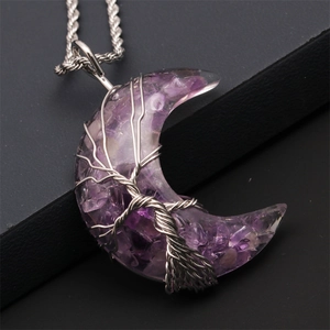 Detail of silver wire wrapped moon pendant with purple amethyst stones and twist chain