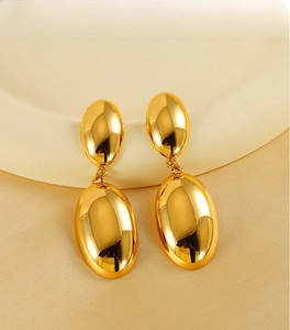 Detailed view of 18K gold plated double oval stud earrings on a velvet jewelry tray