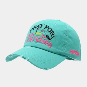 Detail of mint green baseball cap featuring high-quality embroidery and distressed brim