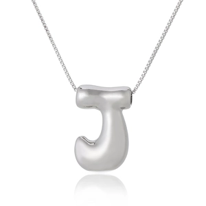 Detailed view of silver capital letter J pendant with polished finish on box chain