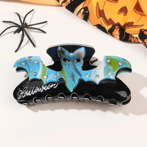Close-up of Halloween bat hair claw clip with rhinestones and marble texture design
