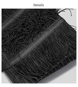 Close-up of black woven shoulder bag showing handmade texture and long tassel details