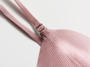 Detail of adjustable strap and ribbed fabric on seamless soft pink wire-free bra