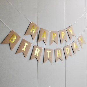 Detail of kraft paper fishtail banner with gold foil Happy Birthday lettering for parties