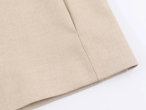 Macro detail of khaki twill fabric texture and precise stitching on the casual blazer