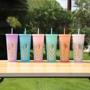 Outdoor lineup of vibrant gradient plastic tumblers with textured diamond pattern