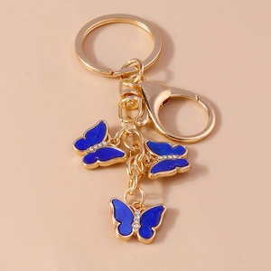 Macro view of blue butterfly keychain with gold finish and sparkling crystal accents