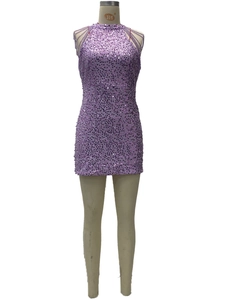 Detail of sequined purple halter dress featuring shimmering texture and mini hemline
