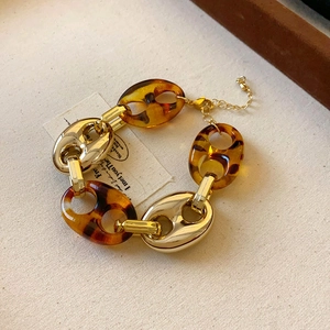 Detail of vintage gold bracelet with tortoiseshell resin links and lobster clasp