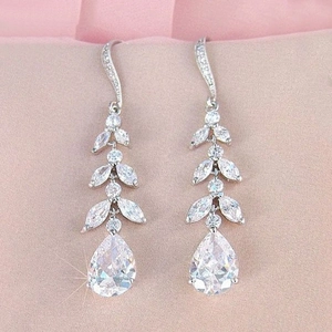 Elegant long tassel leaf-shaped zircon teardrop earrings on a textured background
