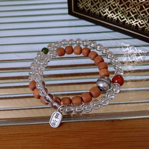 Detail of S925 silver pendant with Bao Fu engraving on crystal and wood bead bracelet