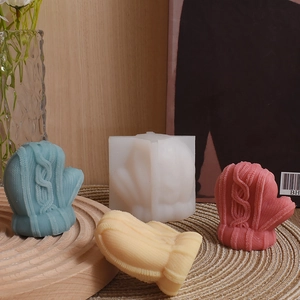 Detail shot of knitted texture on wool glove silicone mold and finished candle crafts
