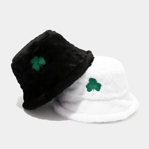 Plush bucket hats with green clover embroidery in black and white colors