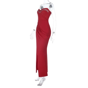 Close-up of red strapless satin dress featuring sparkling rhinestone bodice and side slit