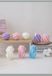 Macro detail of geometric scented candles in purple, pink, and blue artistic shapes