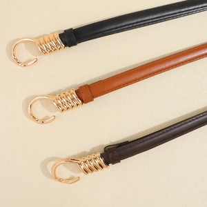 Three elegant slim adjustable leather belts in black and brown with golden spiral buckles