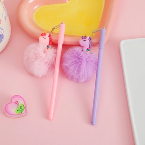 Close-up of cute unicorn gel pens with soft pompom charms in pink and purple colors