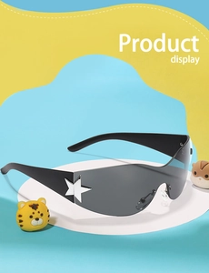 Detail of oversized black kid's sunglasses featuring silver star studs and Y2K trendy style