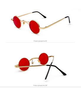 Detail view of steampunk round sunglasses with golden frames and red lenses