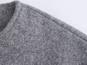 Detail shot of high-quality stitching on charcoal grey wool bomber jacket fabric