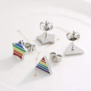 Detail of star and triangle stainless steel earrings with rainbow striped pattern