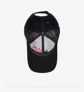 Detail of black baseball cap interior with colorful geometric lining and pink embroidery