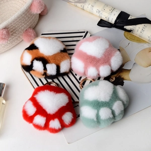 Detailed view of plush cat paw keychains in multiple colors with golden metal rings
