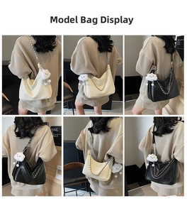Detail showing white and black woven shoulder bags with cloud charms and metal chains