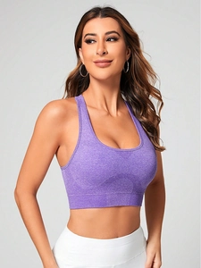 Detail of purple racerback sports bra showing seamless knit texture and breathable mesh