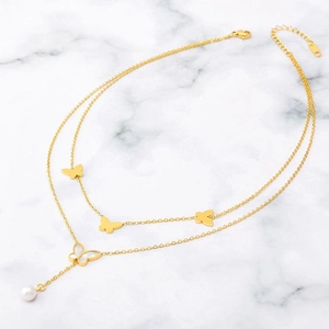 Elegant double-layer gold necklace with butterfly charms and a white pearl drop pendant