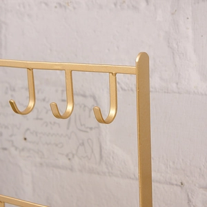 Golden iron jewelry organizer stand with three hooks for earrings and necklaces display