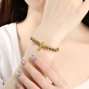 Minimalist 6mm gold beaded bracelet with a cross pendant charm for women