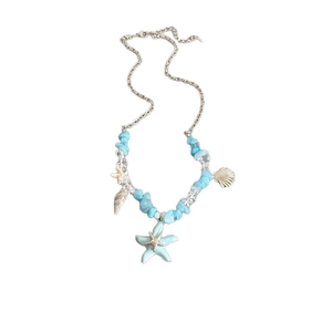Ocean style necklace featuring blue starfish, silver shells, and irregular crystal beads