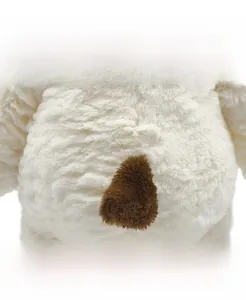 Close-up of the soft white plush fabric and small brown tail of the puppy dog toy