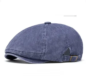 Detail of navy blue vintage newsboy cap showing washed cotton texture and metal side buckle
